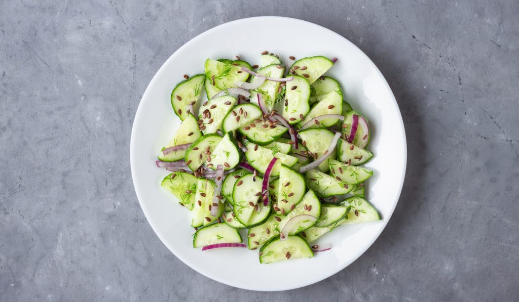 fresh cucumber salad with onions and sesame seeds