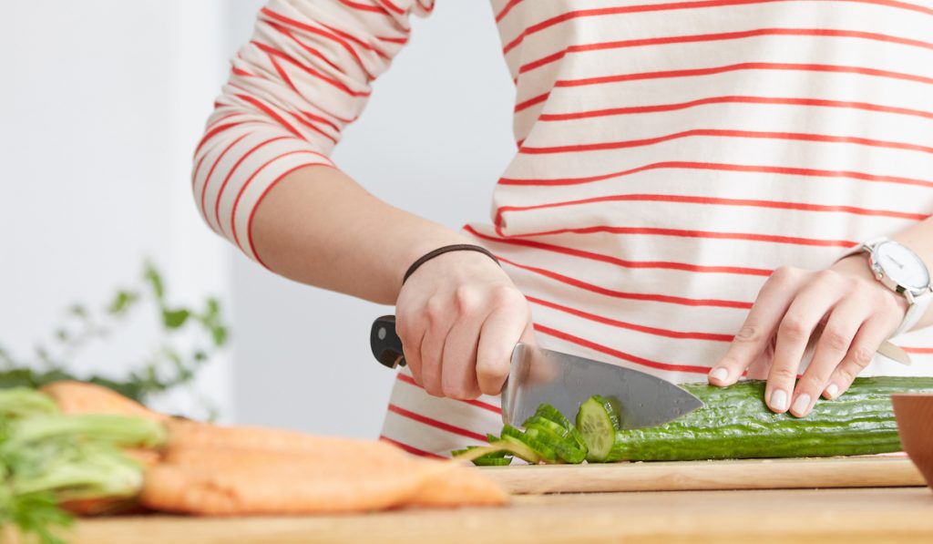 woman slicing cucumber