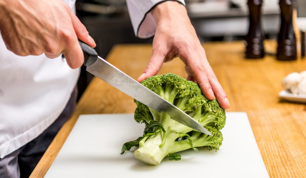 chef cutting broccoli