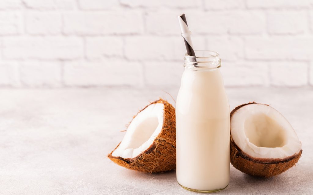 bottle of coconut milk and fresh coconuts