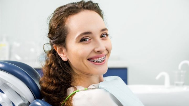 woman with braces in dental clinic - ee220324