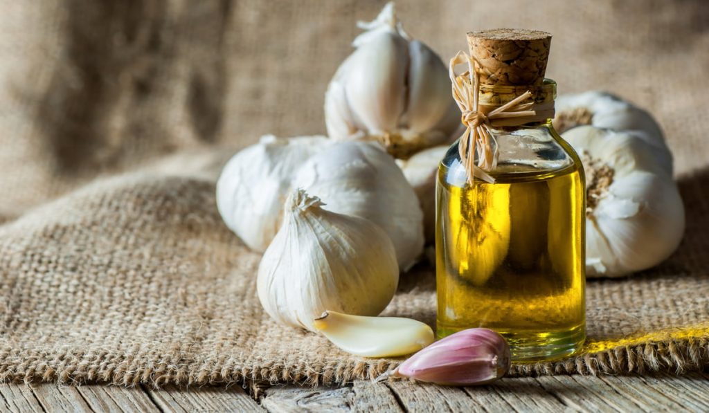 bunch of garlic and a small bottle of garlic oil