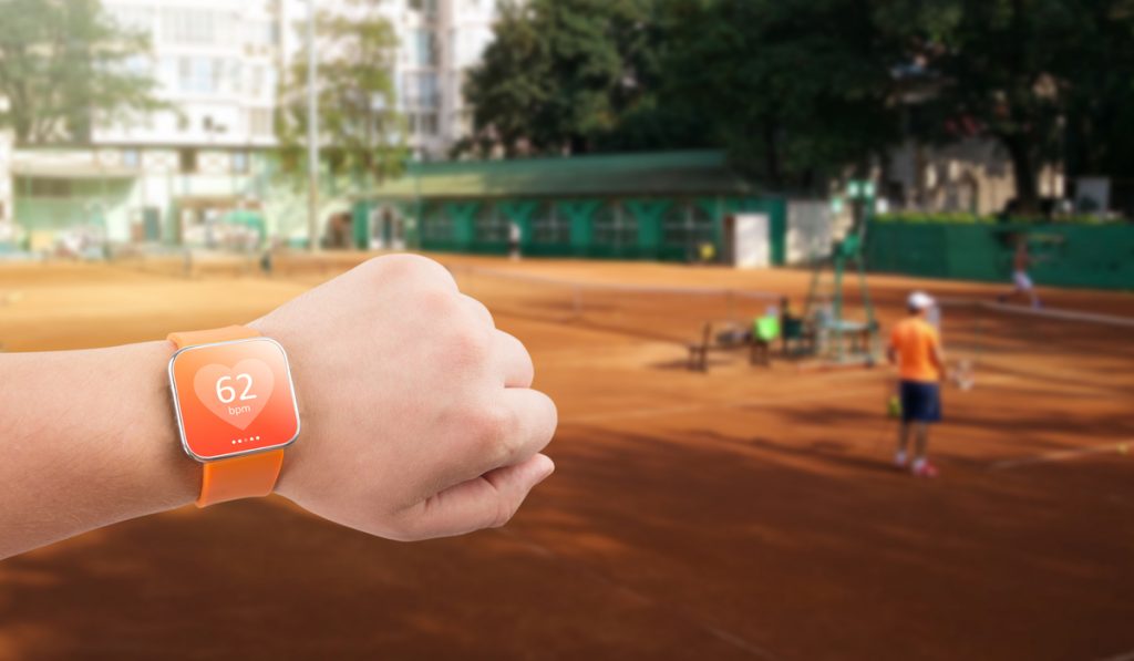 orange heart rate monitor watch orange sports area background 