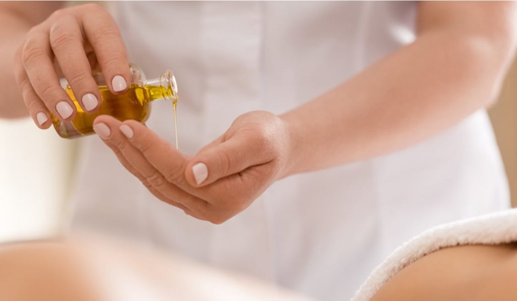 woman pouring oil on her hand